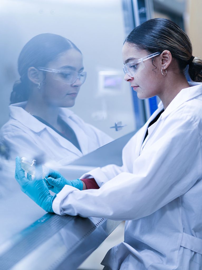 A student works with a petri dish.