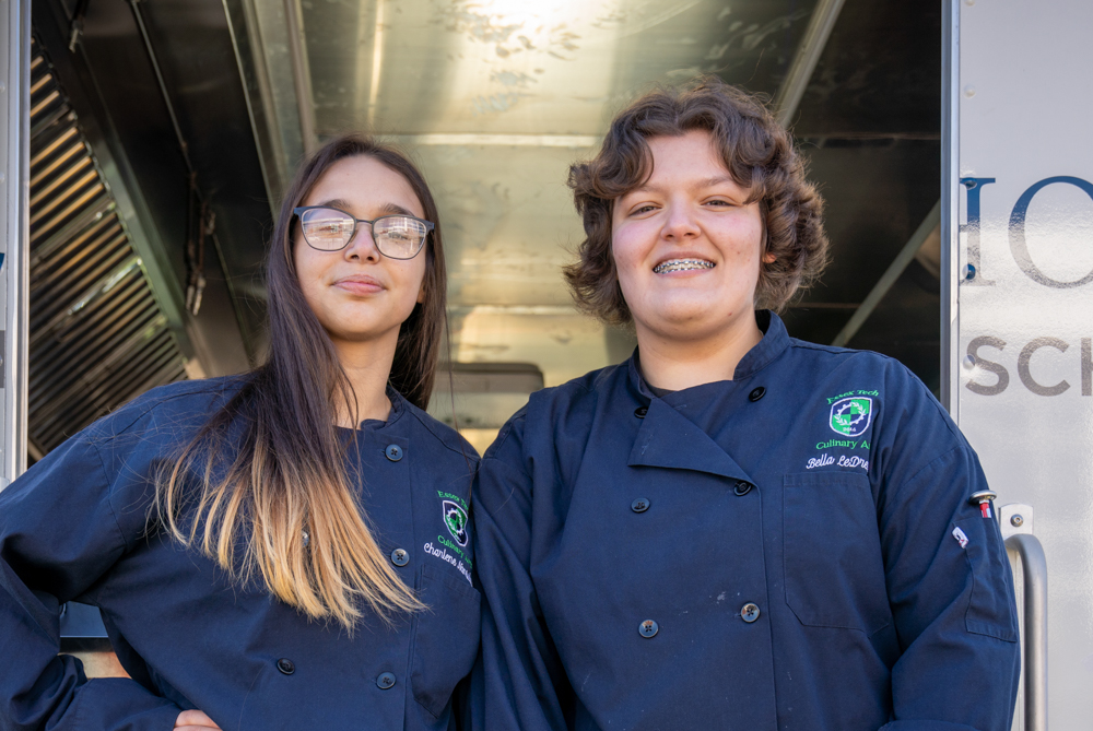 Culinary Arts students giving cookies away from the food truck at the annual open house.